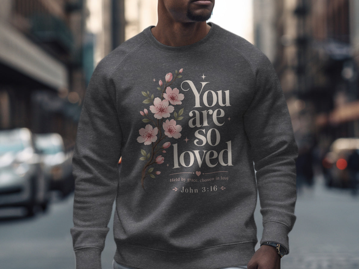 Dark gray sweatshirt with floral design and text "You are so loved".