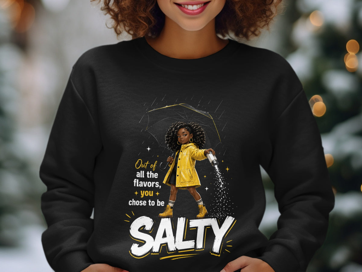 Black sweatshirt with graphic of girl holding umbrella and sprinkling salt, reads "SALTY".