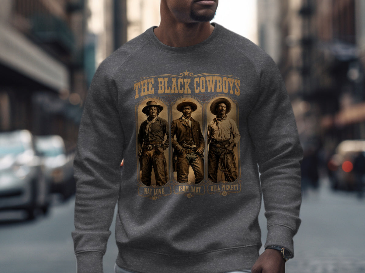 Dark grey sweatshirt with "The Black Cowboys" and portraits of Nat Love, Isom Dart, and Bill Pickett.