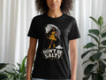 Black t-shirt with "DON'T BE SALTY" text and illustration of a woman with an umbrella and salt shaker.