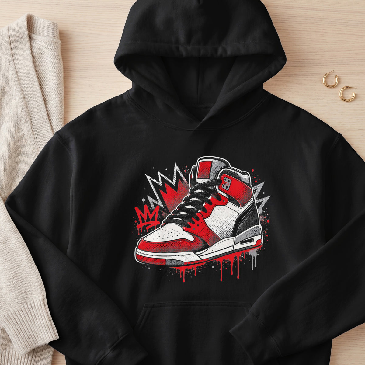 Black hoodie with red, white, and black graphic sneaker design.