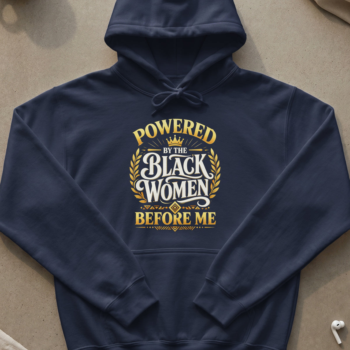 Navy blue hoodie with gold text that reads "Powered by the Black Women Before Me".