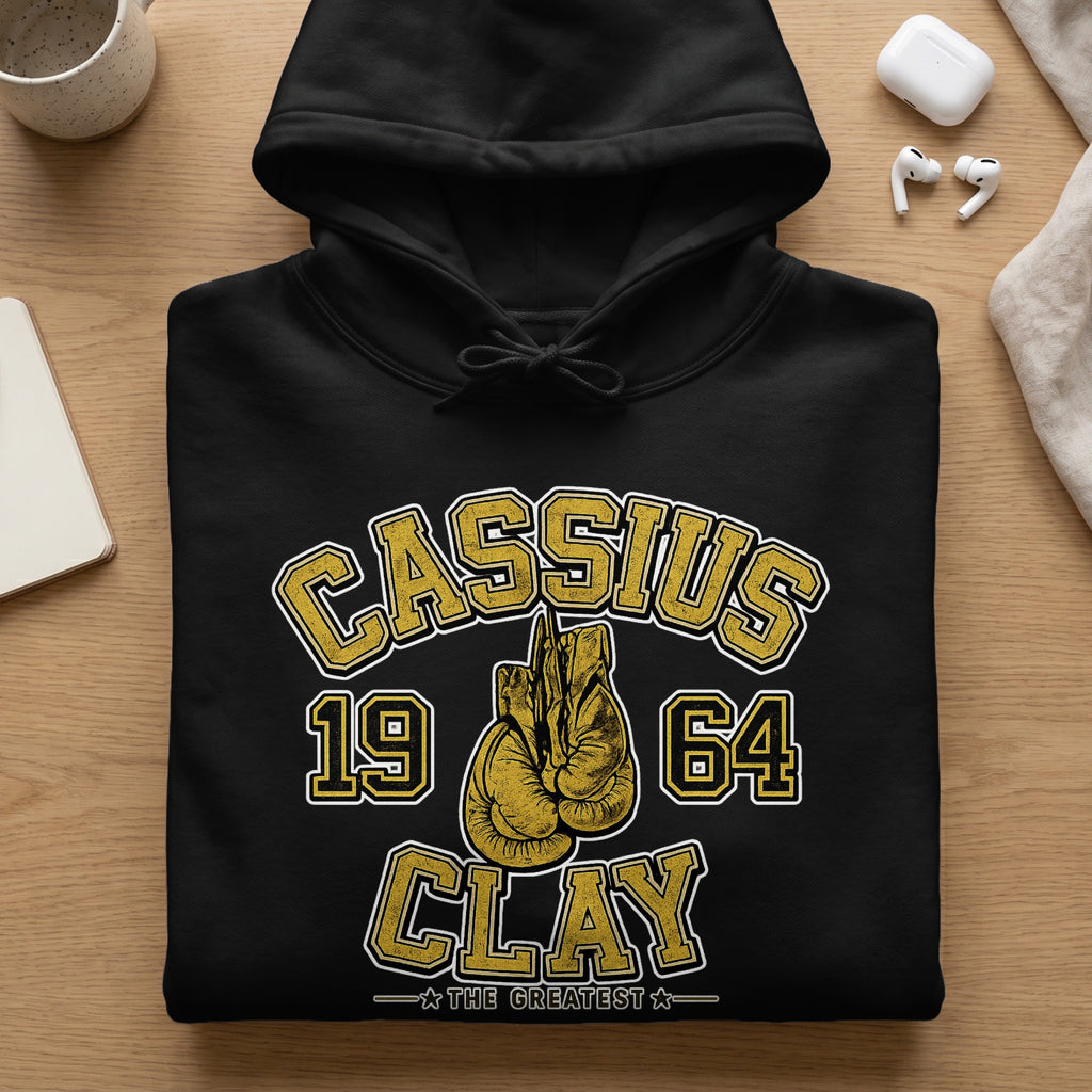 Black hoodie with gold text "Cassius 19 64 Clay The Greatest" and boxing gloves.