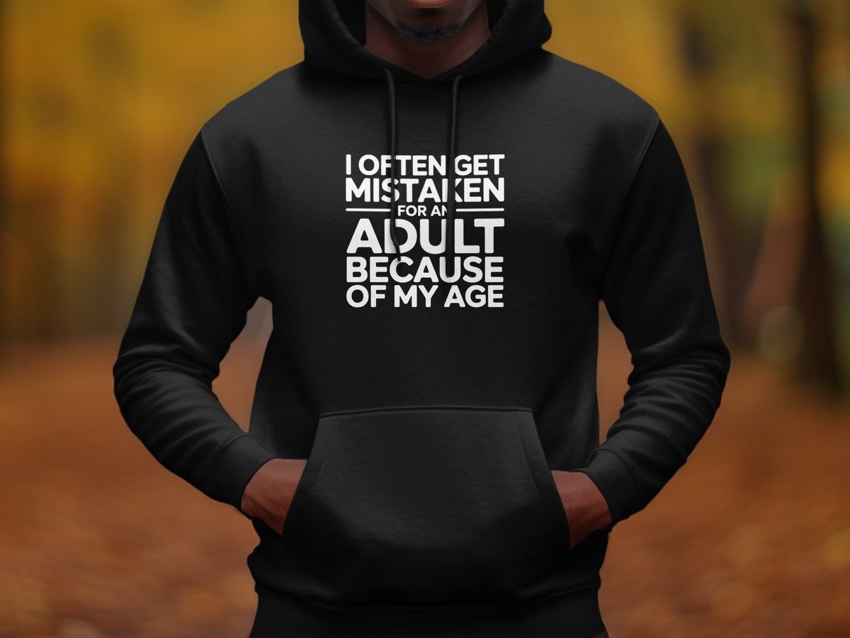 Black hoodie with white text "I OFTEN GET MISTAKEN FOR AN ADULT BECAUSE OF MY AGE".