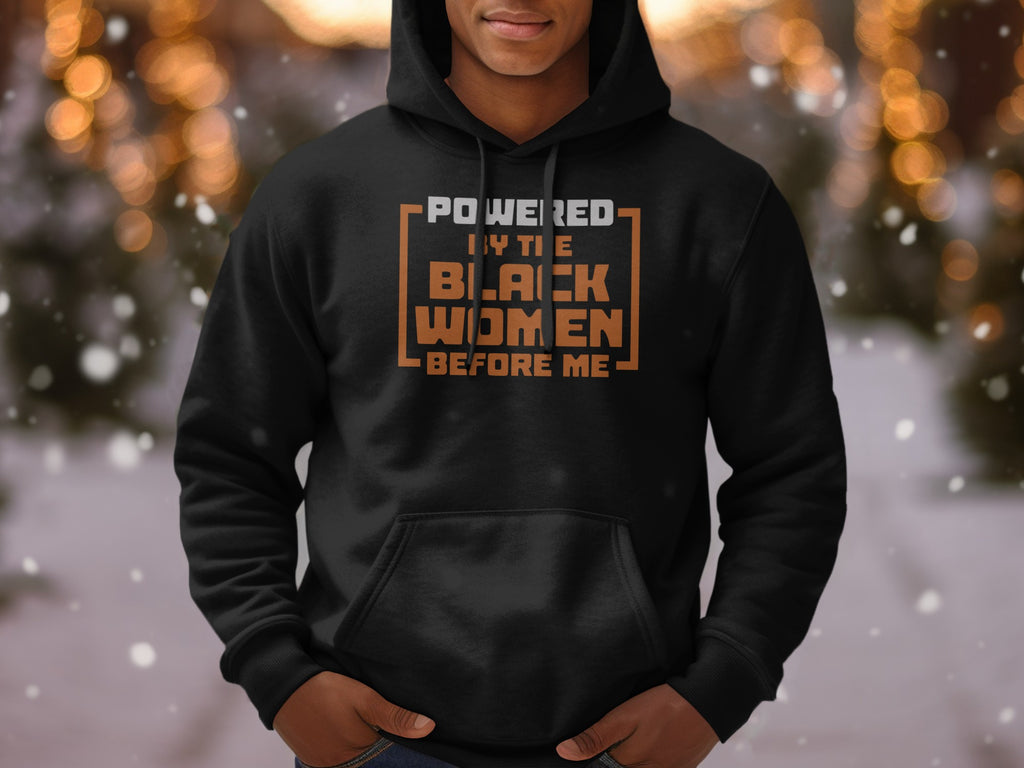 Black hoodie with text "Powered by the Black Women Before Me"