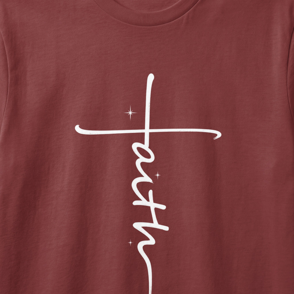 Maroon t-shirt with a white vertical "faith" cross graphic and star accents.