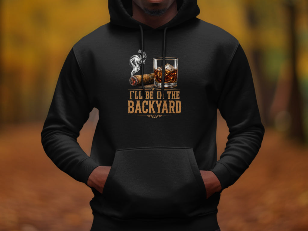 Black hoodie with a cigar, whiskey, and "I'LL BE IN THE BACKYARD" text.