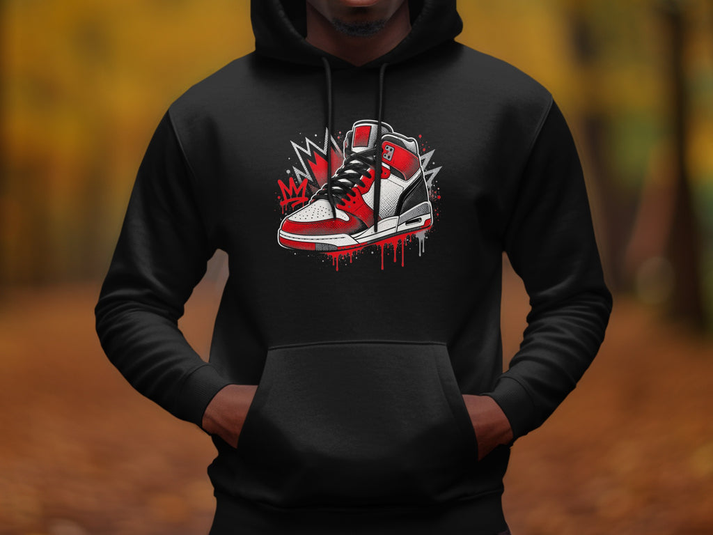 Black hoodie with graphic of red, white, and black sneaker and spray paint splatters.