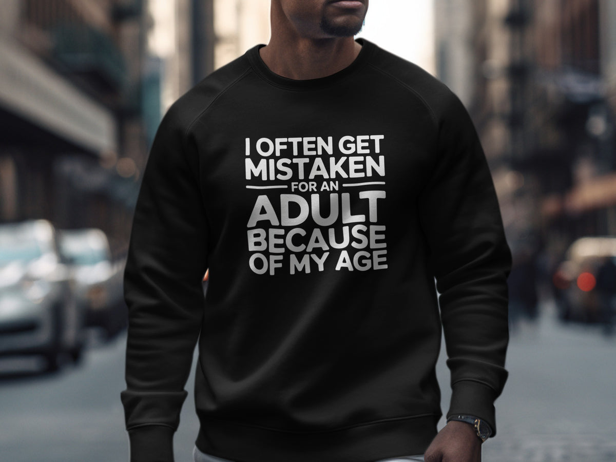 Black sweatshirt with white text: "I OFTEN GET MISTAKEN FOR AN ADULT BECAUSE OF MY AGE."
