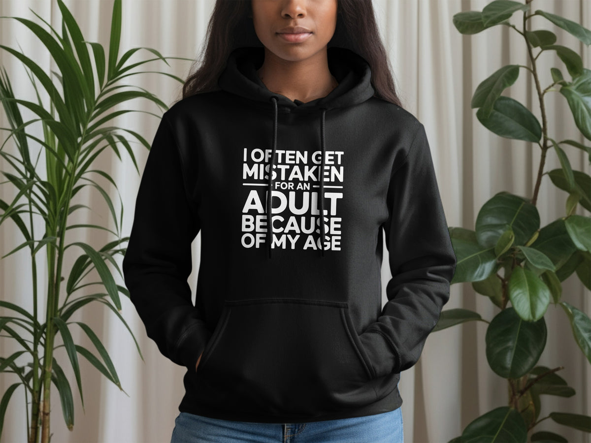 Black hoodie with white text "I often get mistaken for an adult because of my age."