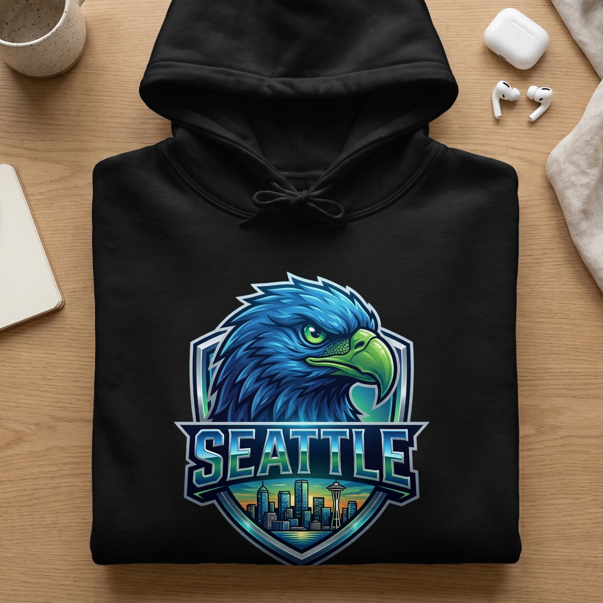 Black hoodie with a Seattle cityscape and eagle emblem.