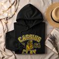 Black hoodie with "Cassius Clay 1964" text and boxing gloves graphic.