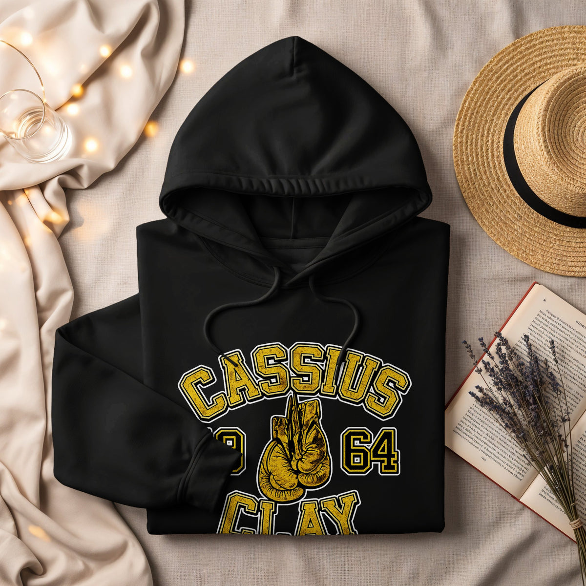 Black hoodie with "Cassius Clay 1964" text and boxing gloves graphic.