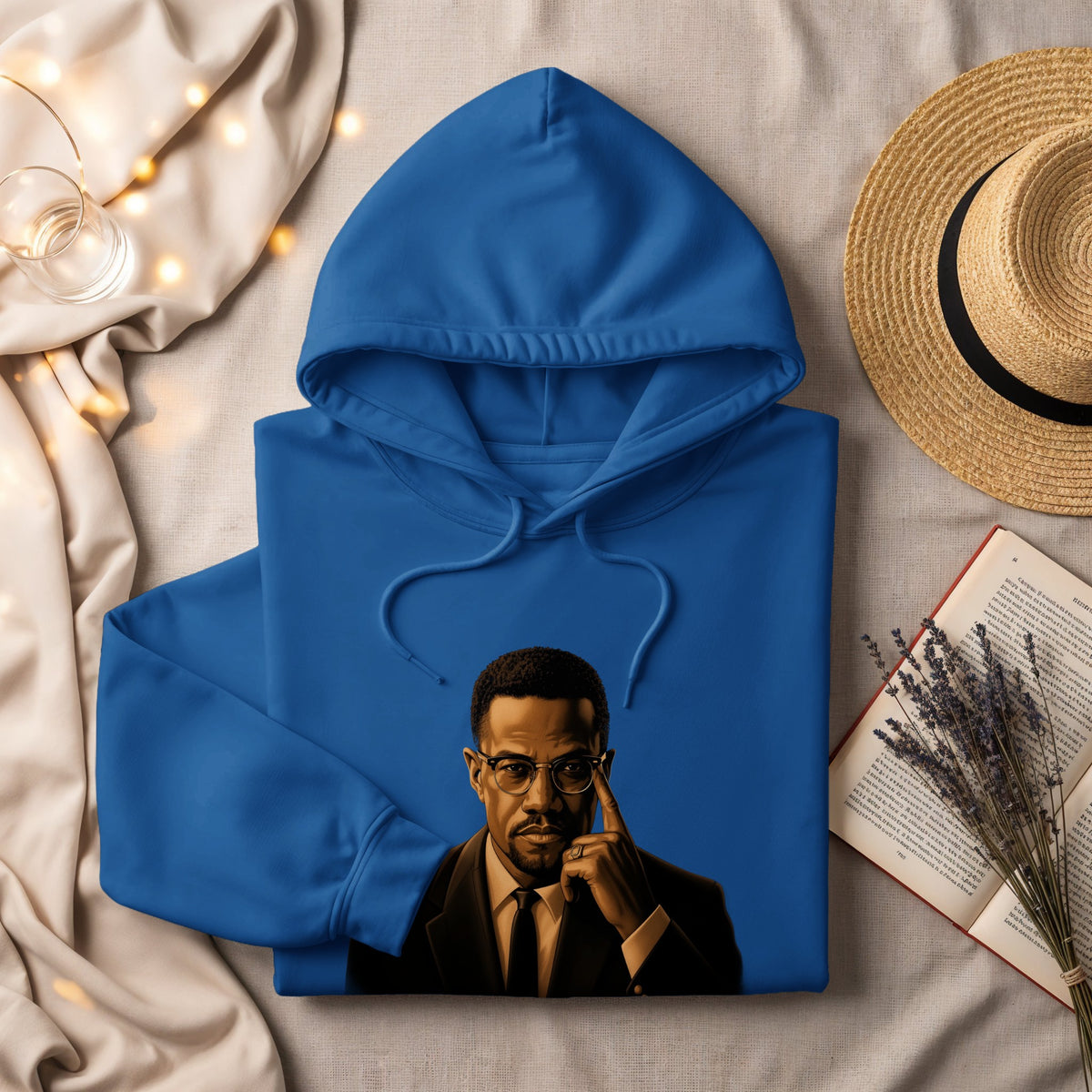Blue hoodie with a portrait of Malcolm X wearing glasses.