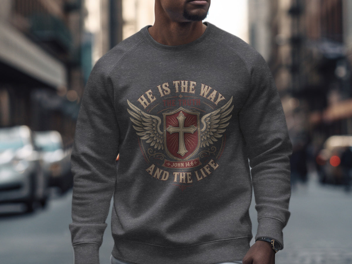 Dark gray sweatshirt with a circular Christian design featuring a cross, wings, and text.