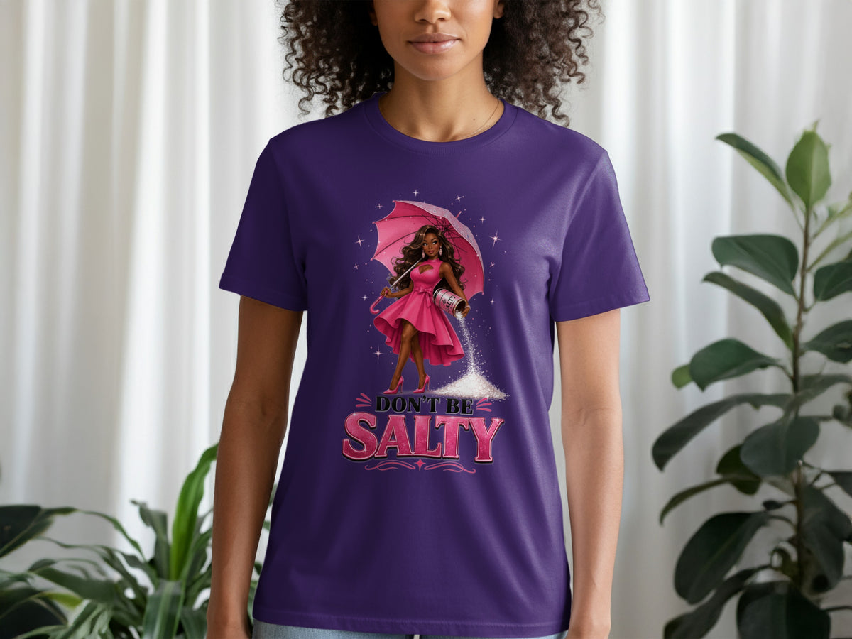 Purple t-shirt with graphic of woman holding umbrella and sprinkling salt with text "DON'T BE SALTY."