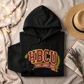 Black hoodie with "HBCU Excellence Legacy Pride" text and laurel wreath.