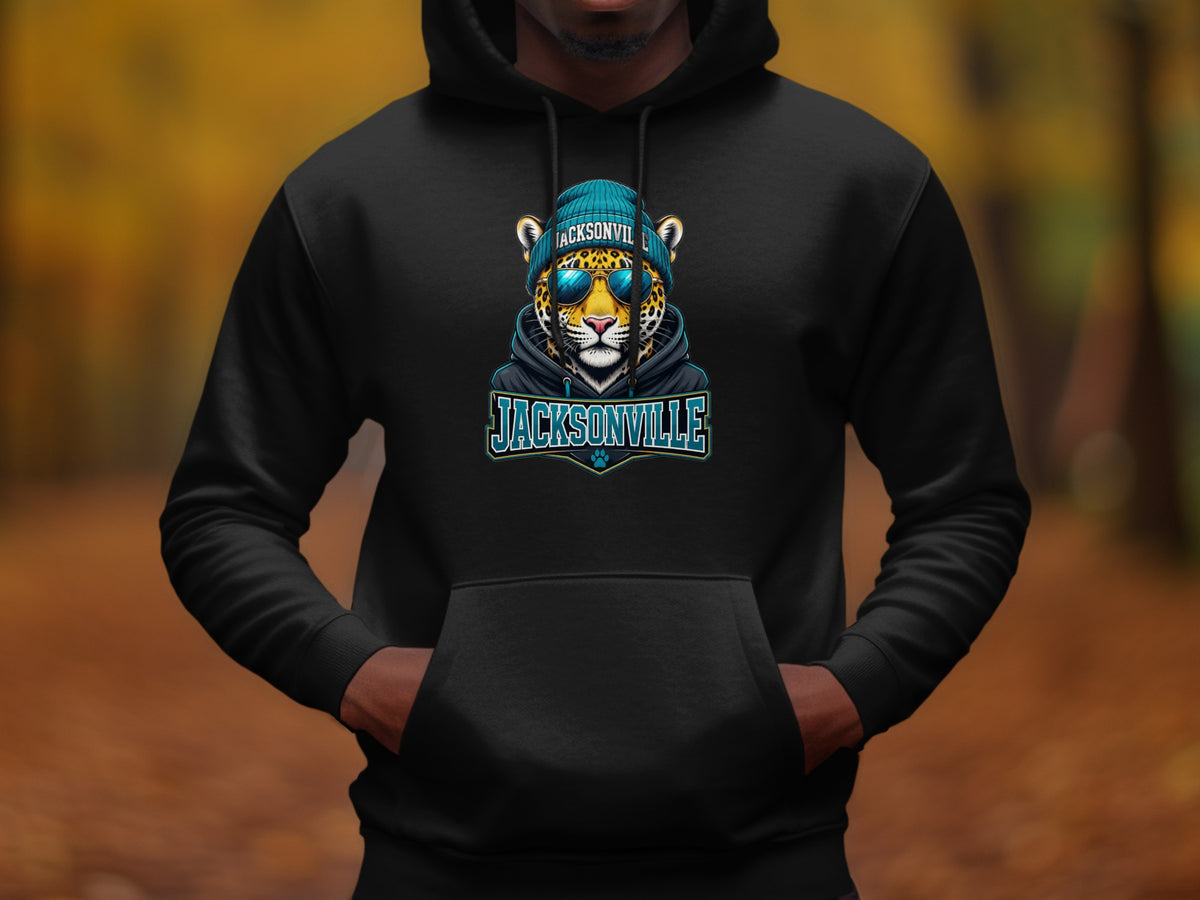 Black hoodie with a Jacksonville jaguar graphic wearing a teal beanie and sunglasses.