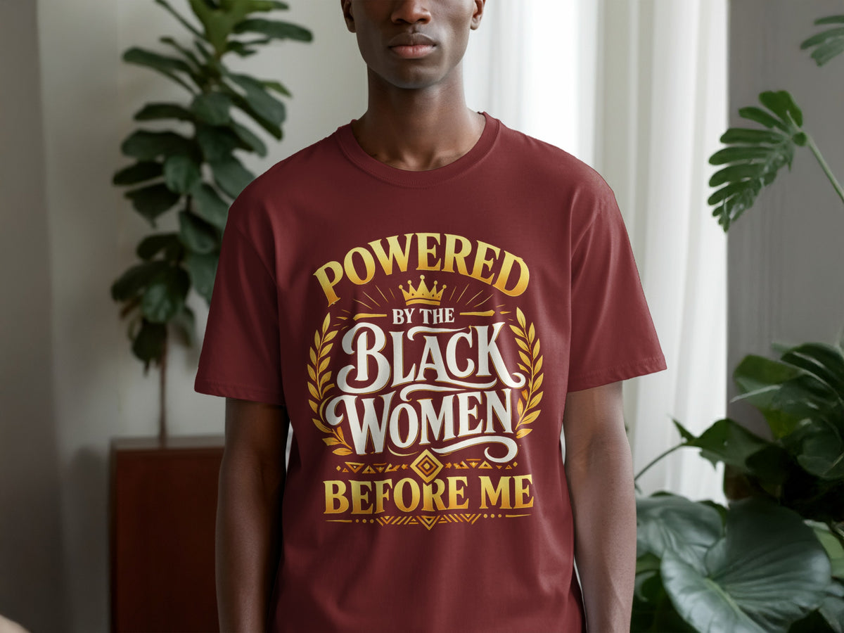 Maroon t-shirt with gold text: "Powered by the Black Women Before Me."