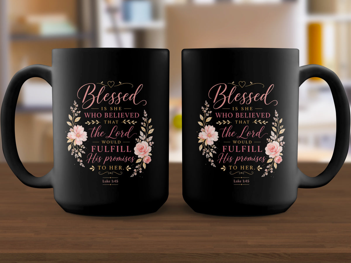 Two black mugs with floral designs and the text "Blessed is she who believed that the Lord would fulfill His promises to her. Luke 1:45."