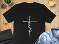 Black t-shirt with white cursive "Faith" text forming a cross.