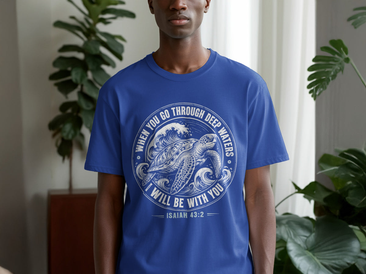 Blue t-shirt with a circular graphic of a sea turtle and waves, reading "When you go through deep waters I will be with you Isaiah 43:2".