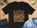 Black t-shirt with groovy text reading "BROWN SUGAR BABE"