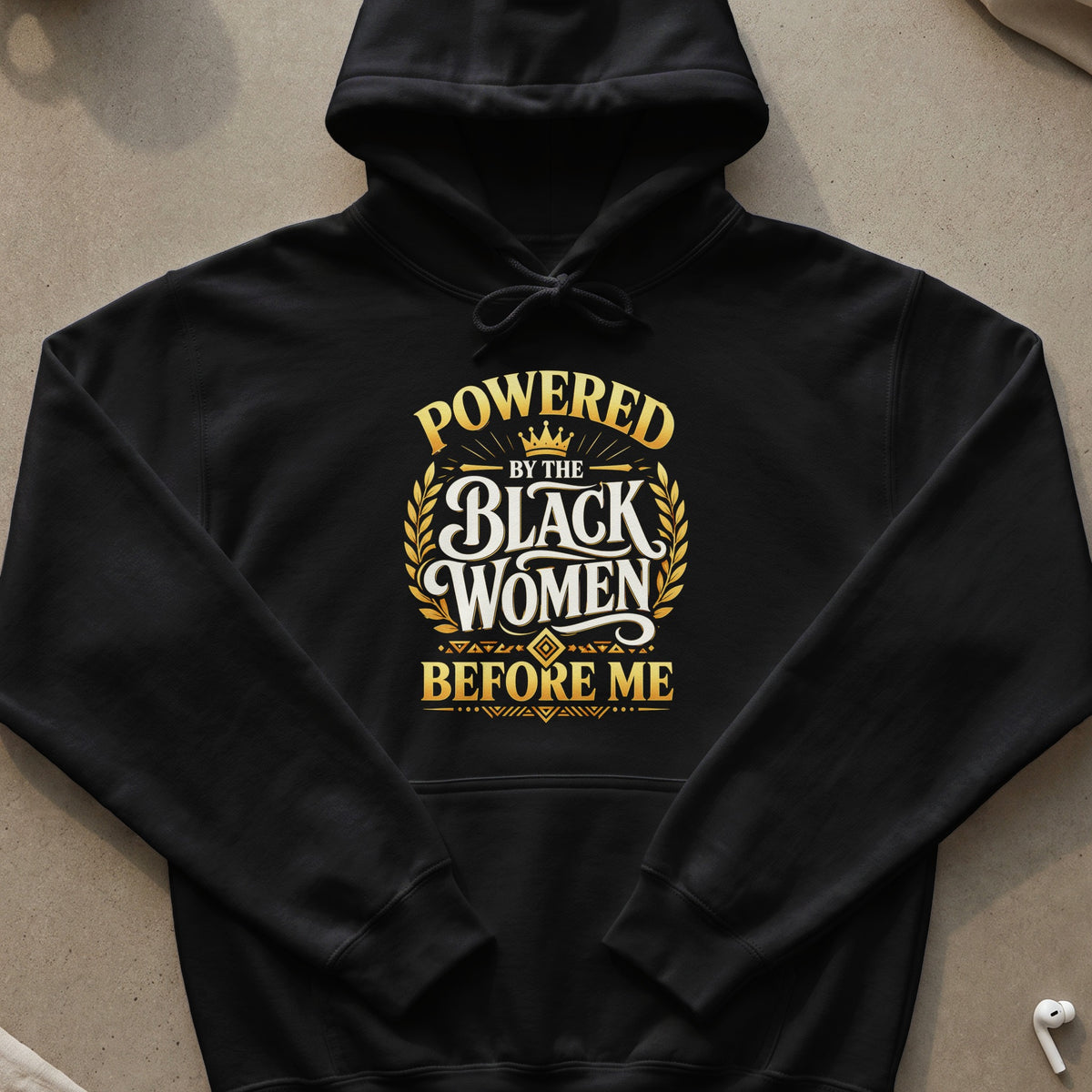 Black hoodie with "Powered by the Black Women Before Me" text design.