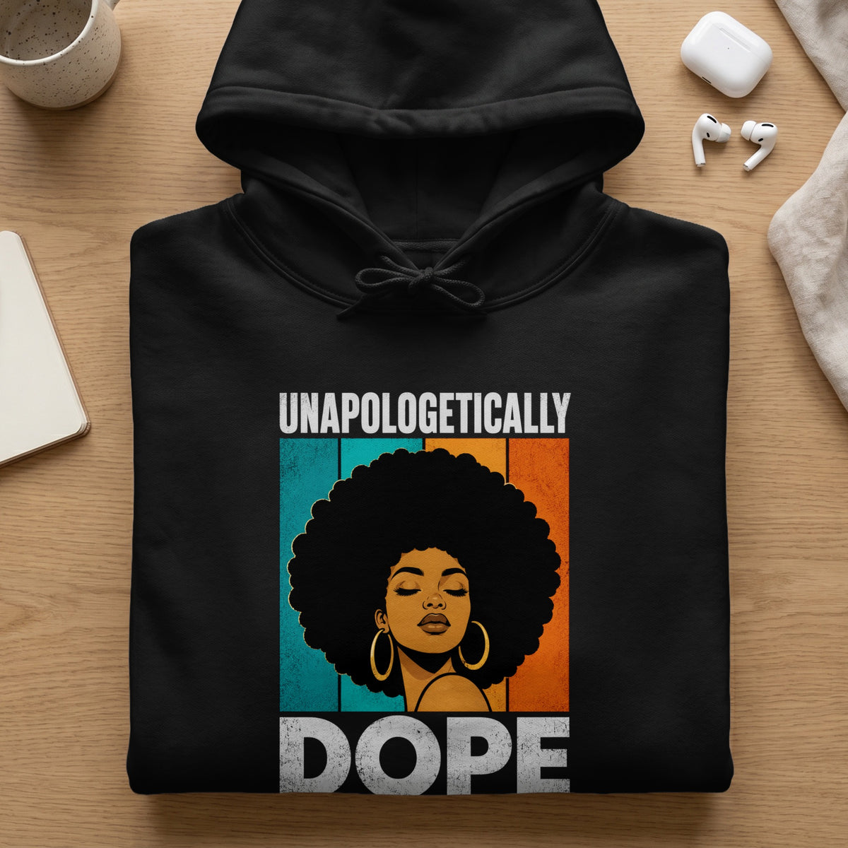 Black hoodie with graphic of a woman with afro and text "UNAPOLOGETICALLY DOPE".