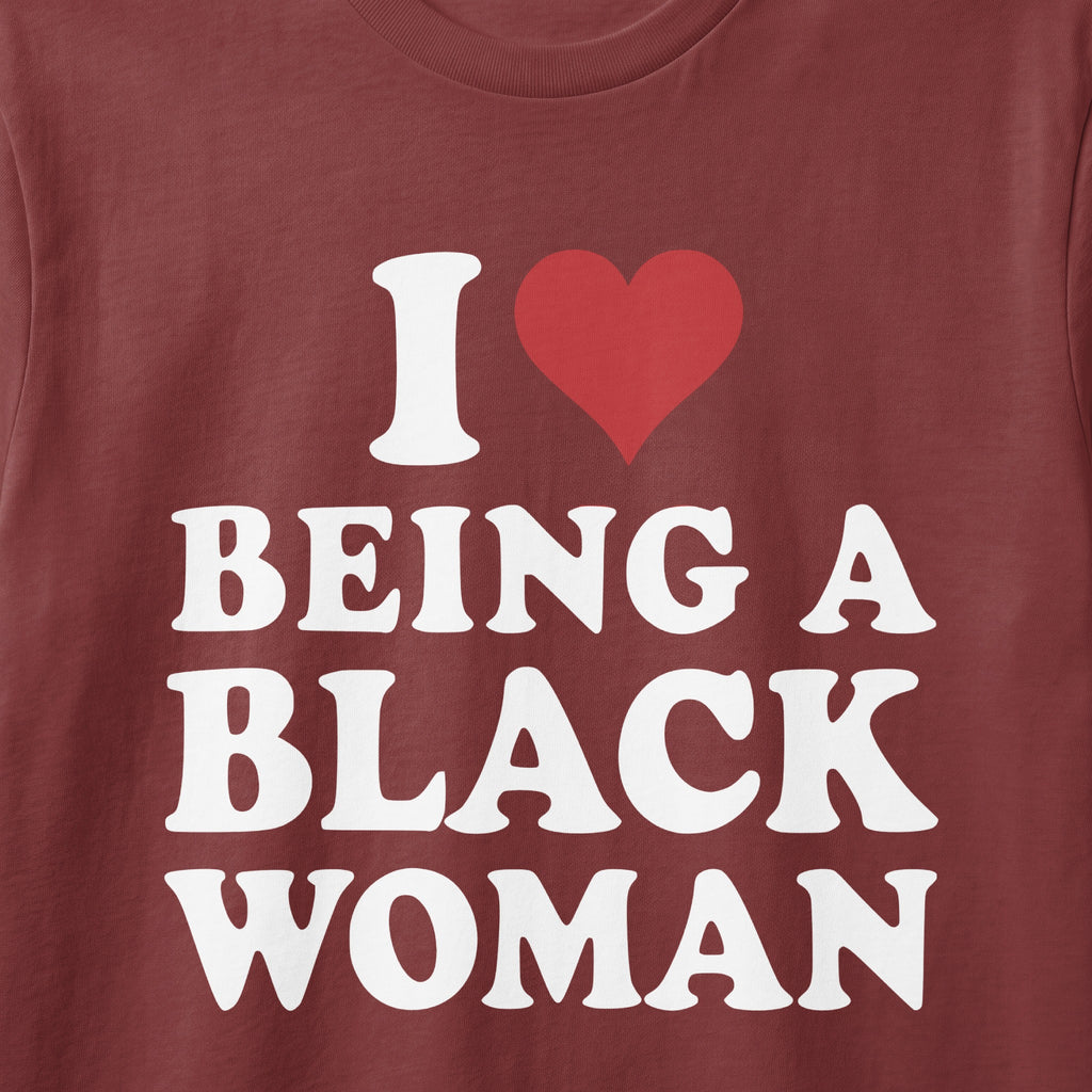 Maroon t-shirt with white text: "I ♥ BEING A BLACK WOMAN"