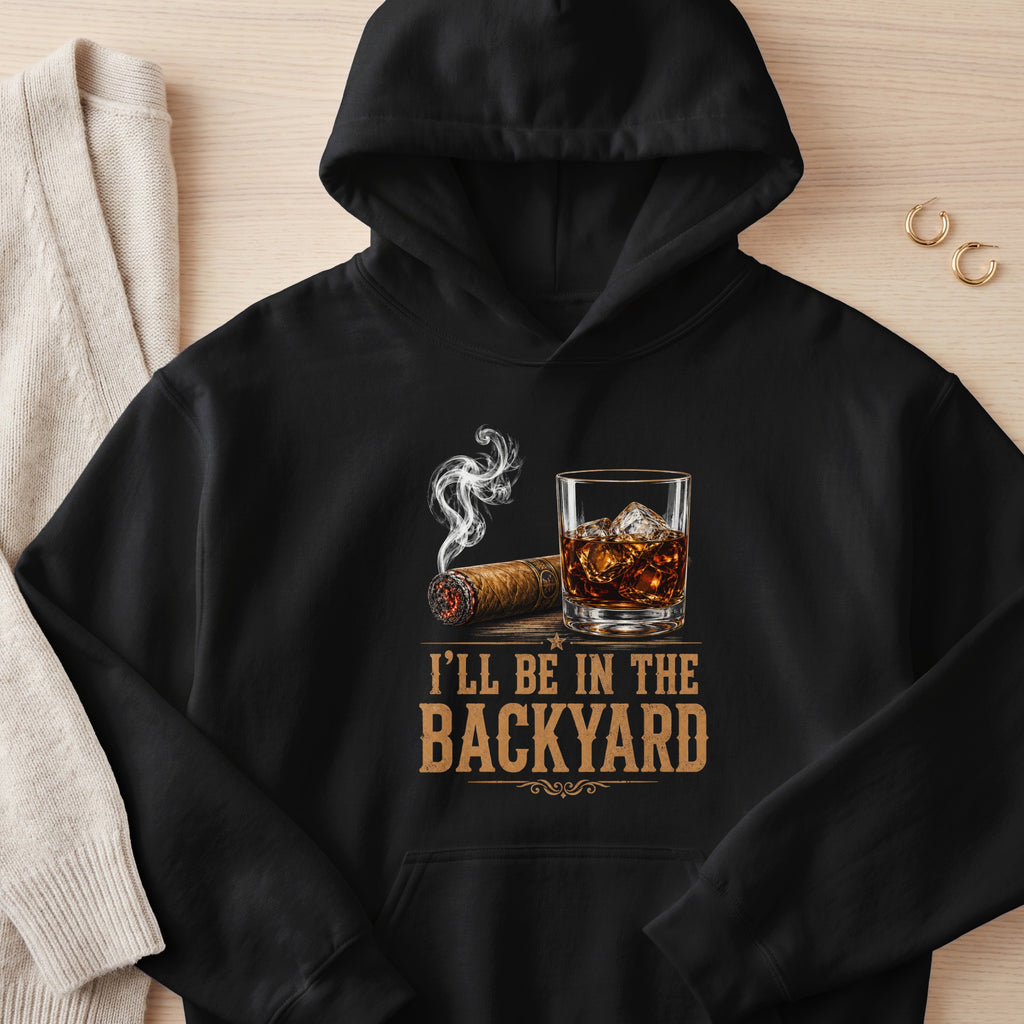 Black hoodie with cigar, whiskey glass, and text "I'LL BE IN THE BACKYARD".