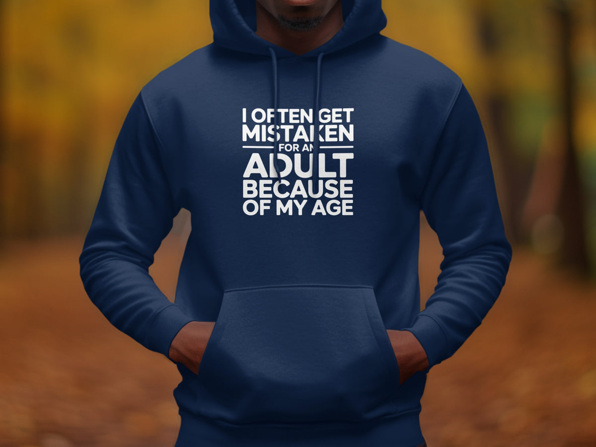Navy hoodie with white text reading "I OFTEN GET MISTAKEN FOR AN ADULT BECAUSE OF MY AGE."