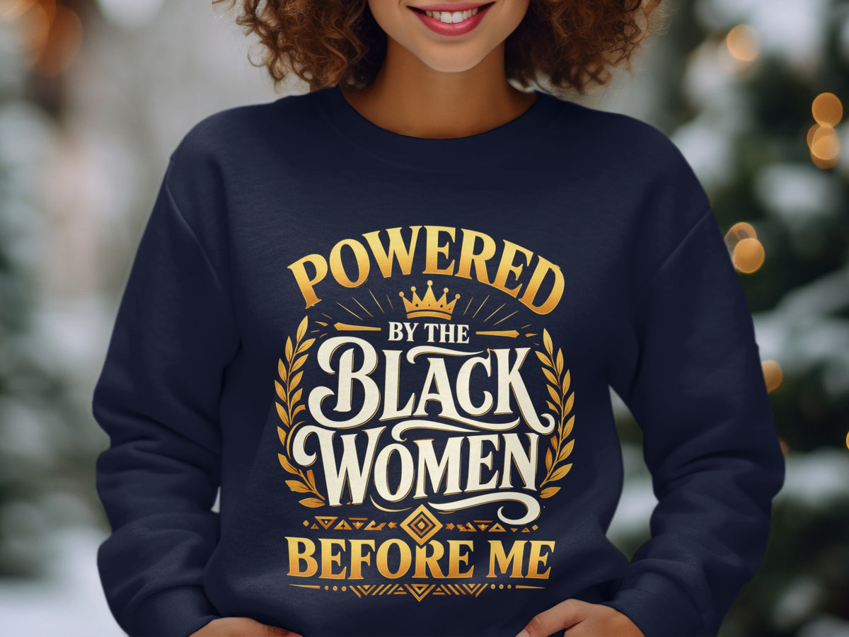 Navy sweatshirt with text "Powered By The Black Women Before Me" in gold.