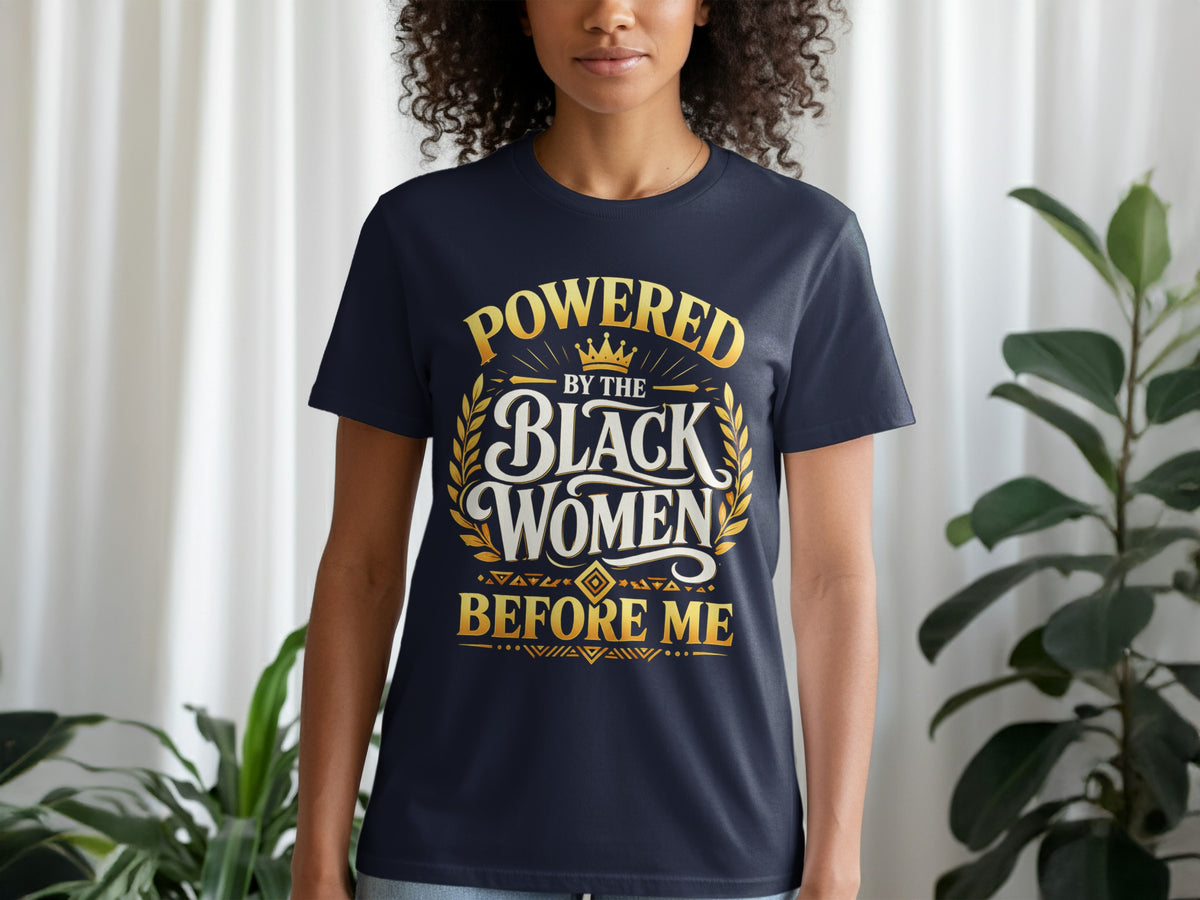 Navy t-shirt with gold text reading "POWERED BY THE BLACK WOMEN BEFORE ME".