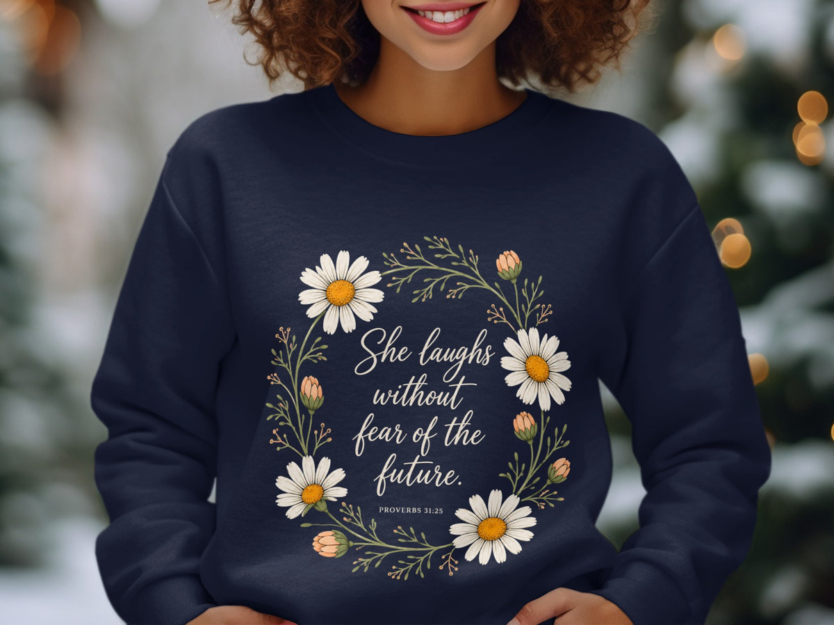 Navy sweatshirt with floral wreath and text "She laughs without fear of the future. Proverbs 31:25."