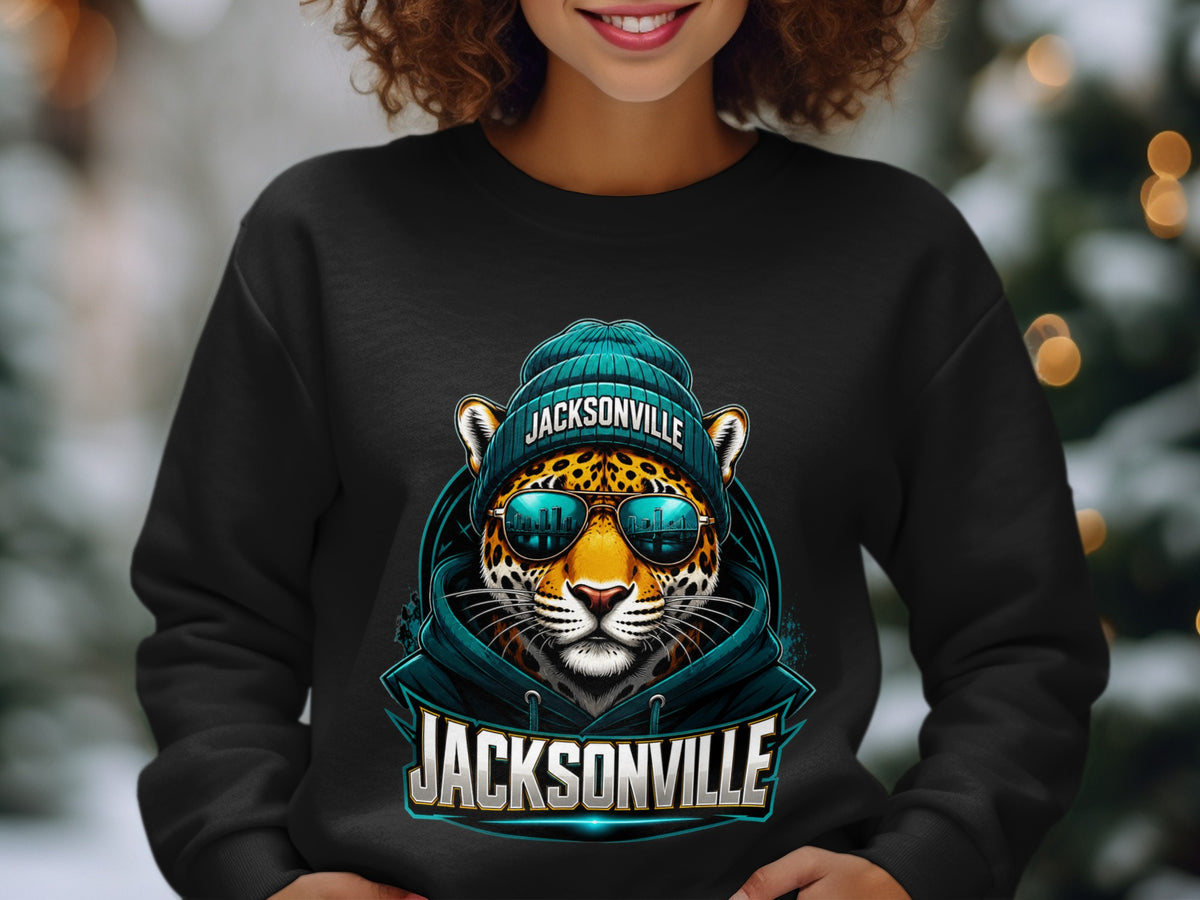 Black sweatshirt with a graphic of a jaguar wearing a beanie and sunglasses with Jacksonville skyline reflection.