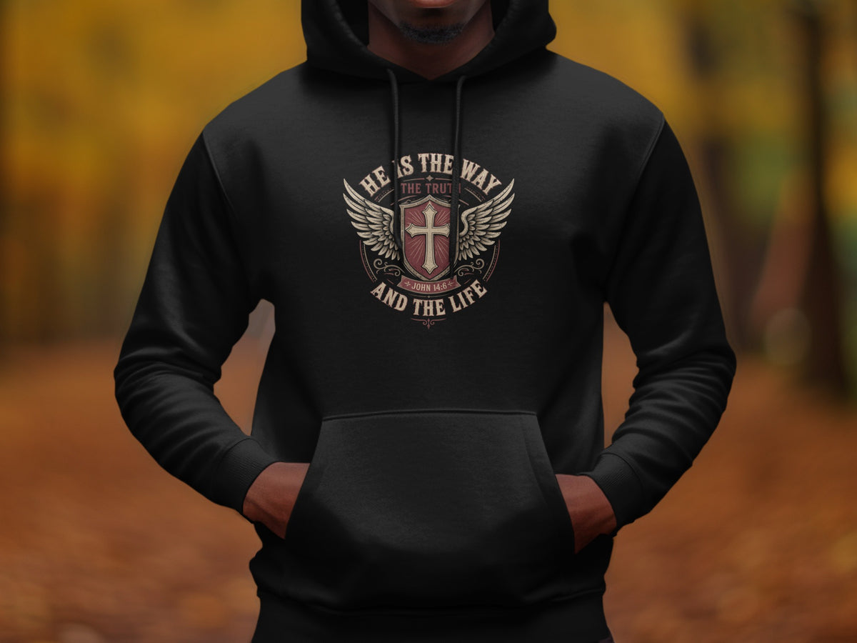 Black hoodie with a shield logo featuring a cross, wings, and text "He is the way the truth and the life".