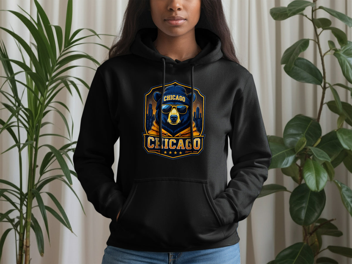 Black hoodie with a Chicago bear graphic wearing sunglasses and a beanie.