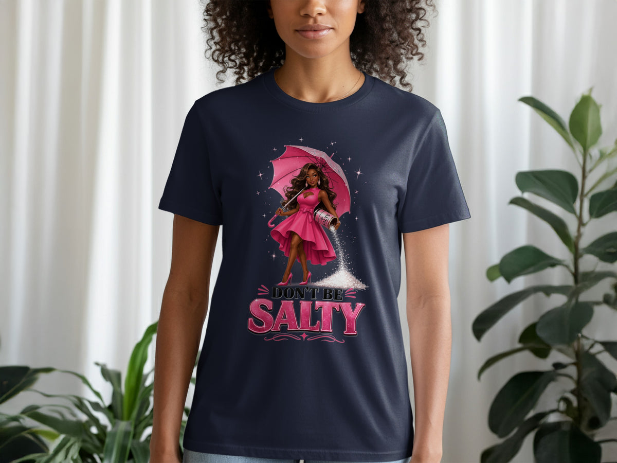 Navy t-shirt with graphic of woman holding pink umbrella and pouring salt with text "DON'T BE SALTY".