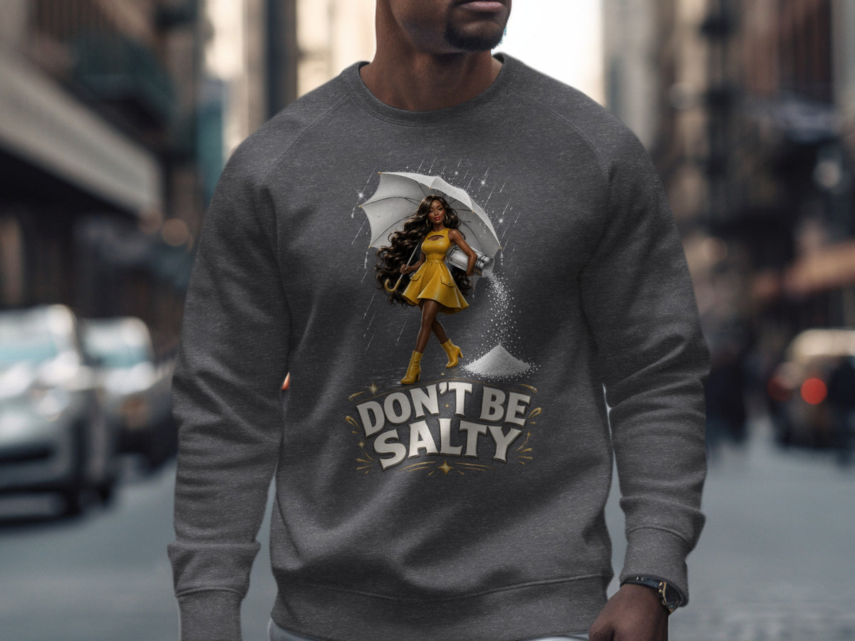 Gray sweatshirt with a graphic of a woman holding an umbrella with a salt shaker spilling salt.