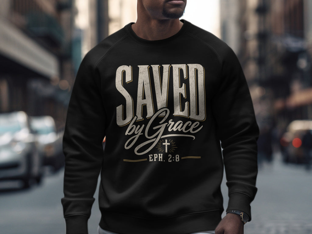 Black sweatshirt with "SAVED by Grace" and "EPH. 2:8" text and a cross design.