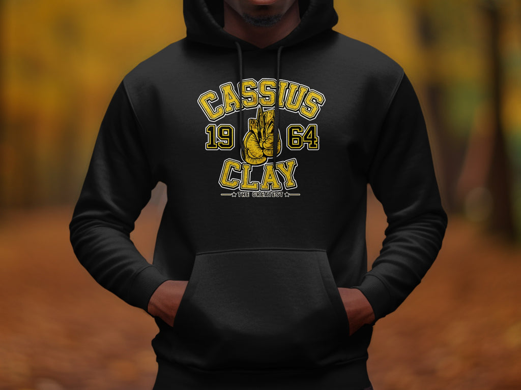 Black hoodie with "Cassius 1964 Clay The Greatest" graphic and boxing gloves.