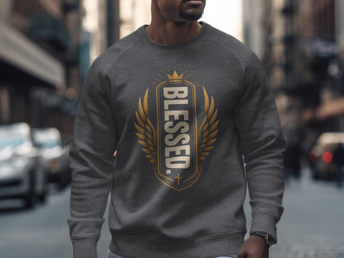 Dark gray crewneck sweatshirt with "BLESSED" text and gold crown and wings design.