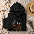 Black hoodie with cigar, whiskey, and text that reads "I'LL BE IN THE BACKYARD".