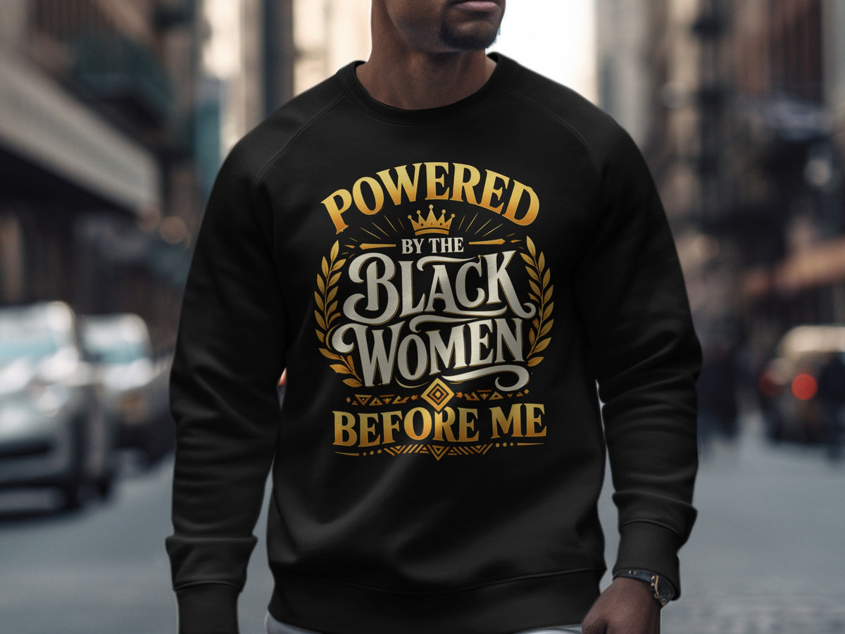 Black sweatshirt with "Powered by the Black Women Before Me" text and crown graphic.