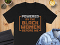Black t-shirt with text "POWERED BY THE BLACK WOMEN BEFORE ME".