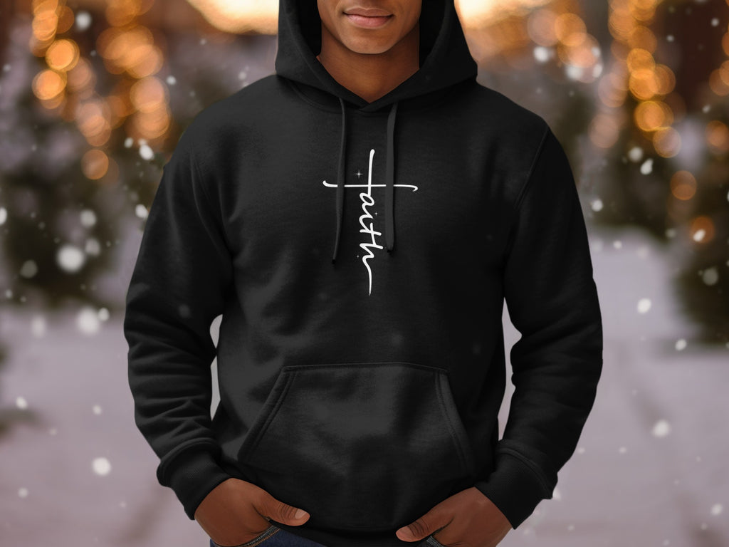 Black hoodie with white script "Faith" cross graphic and bokeh background.