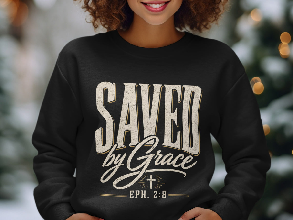 Black sweatshirt with "SAVED by Grace EPH. 2:8" text and a cross emblem.