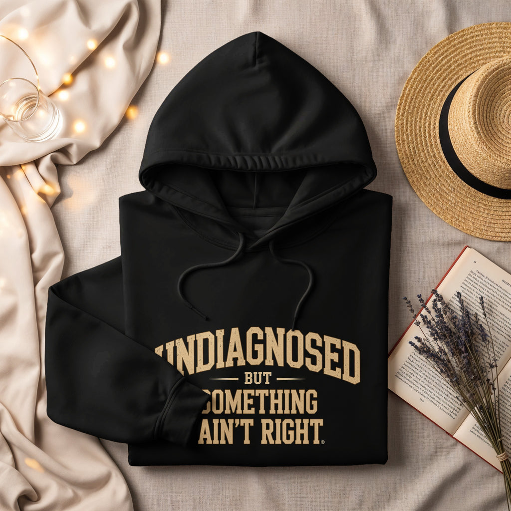 Black hoodie with text "undiagnosed but something ain't right."