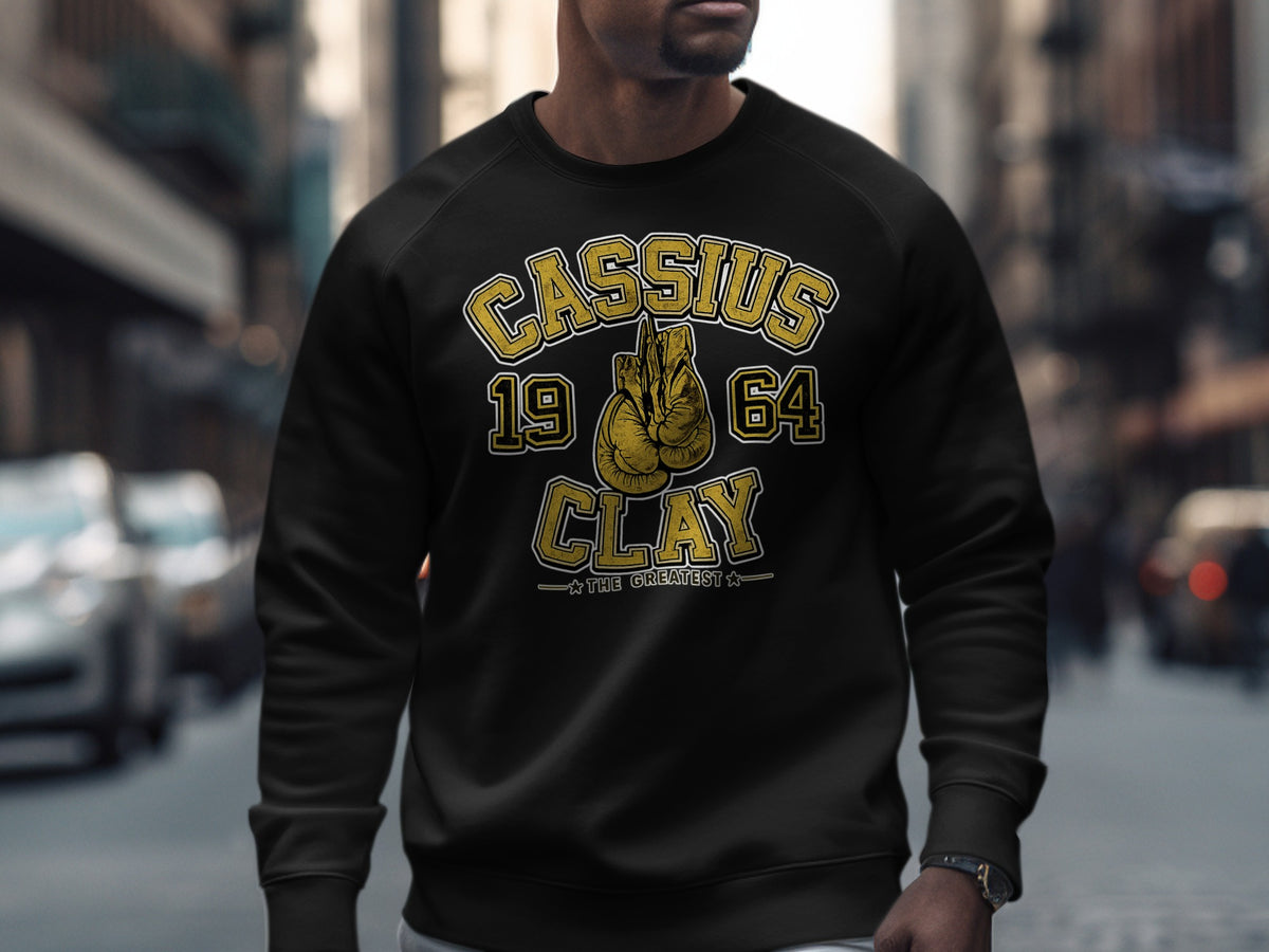 Black sweatshirt with "Cassius Clay 1964 The Greatest" and boxing gloves graphic.